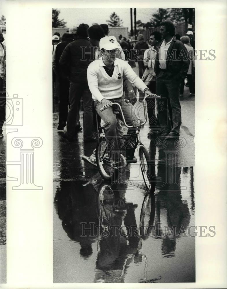 1983 Press Photo Teo Fabi rides a bicycle thru the garage area - cvb70492 - Historic Images