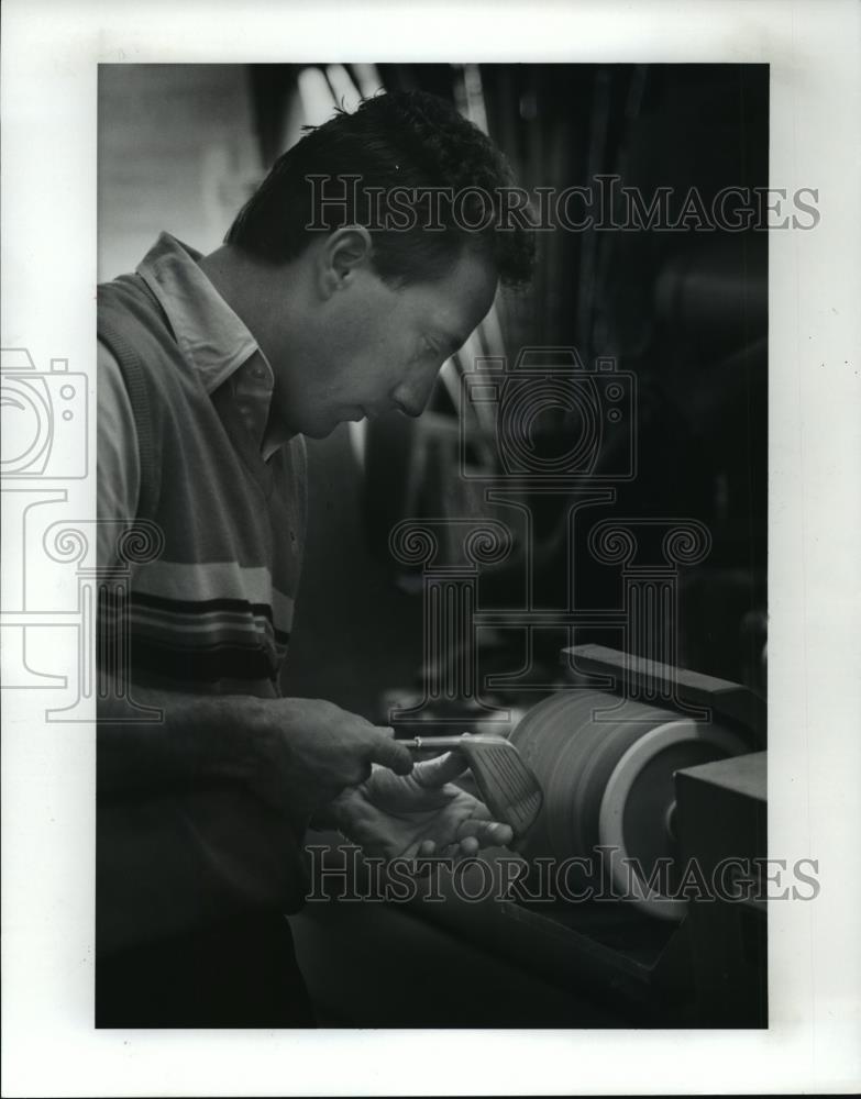 Press Photo Dave Moskal sands a metal wood that he is refinishing. - cvb71903 - Historic Images