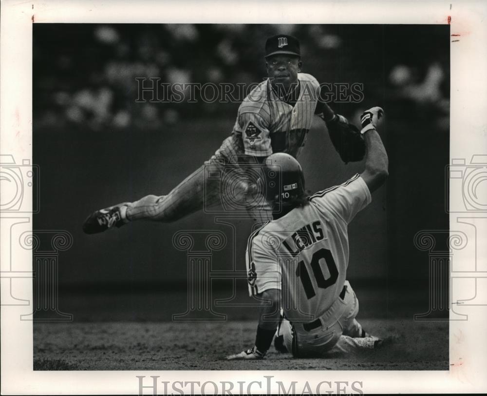 Press PhotoAl Newman throws to first while Indians, Mark Lewes slides into base - Historic Images