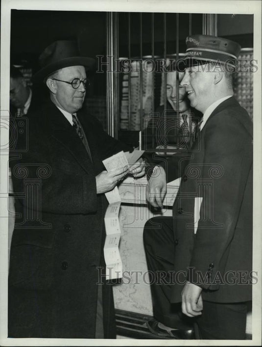 1936 Press Photo Mc Nichols looking over railway tickets - cvb72587 - Historic Images