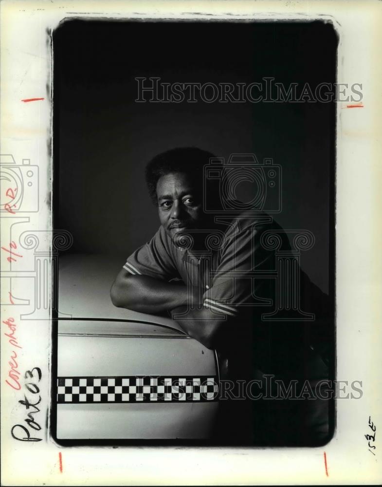 1985 Press Photo A Roman Sapecki photograph, Man on Taxi. - cvp98508 - Historic Images