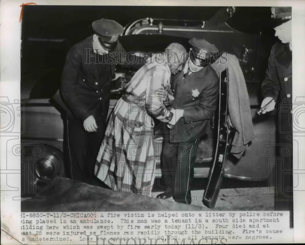 1949 Press Photo Chicago Apartment Fire Victim Helped by Police - nef07066 - Historic Images