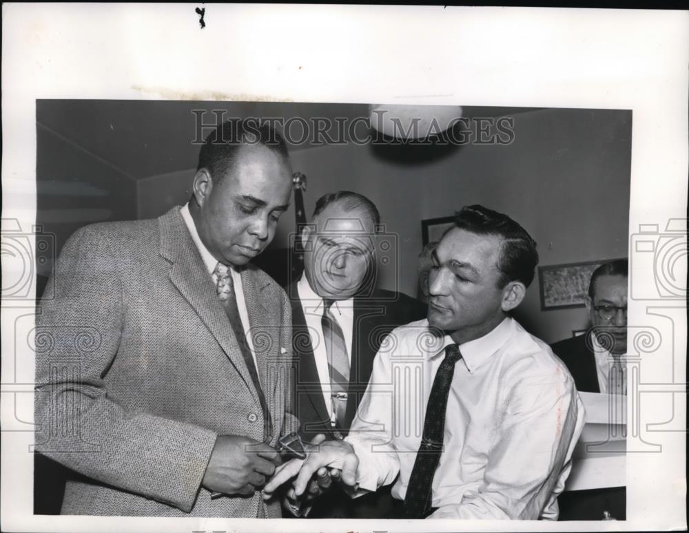 1957 Press Photo Doctor checks hand of boxer Carmen Basilio, comm. Dave Ott - Historic Images