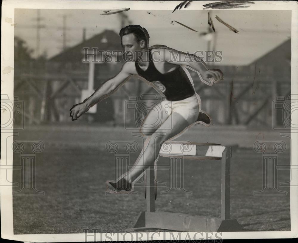 1928 Press Photo Hurdler J. Grumbles clears the barrier while running hurdles - Historic Images
