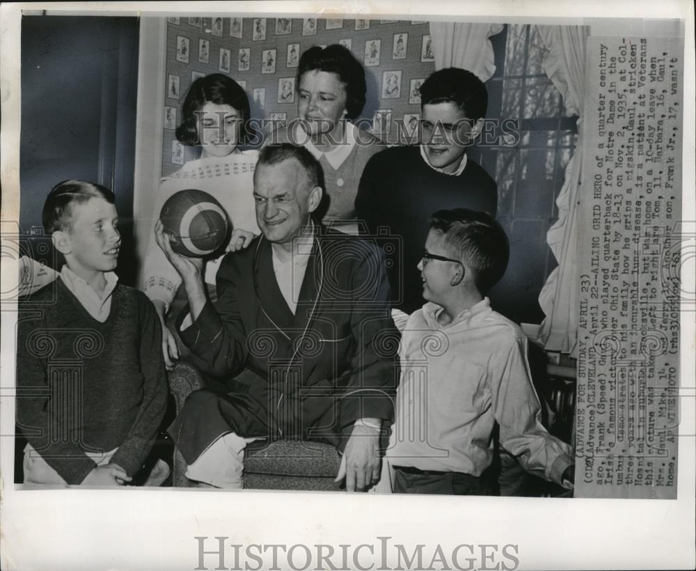 1961 Press Photo Former quarterback Frank Gaul shows his family his football. - Historic Images