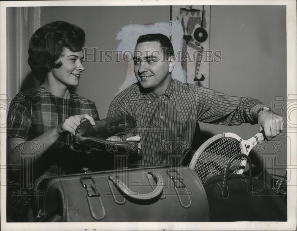 1962 Press Photo Ken McBride puts away racquet after playing with his wife. - Historic Images