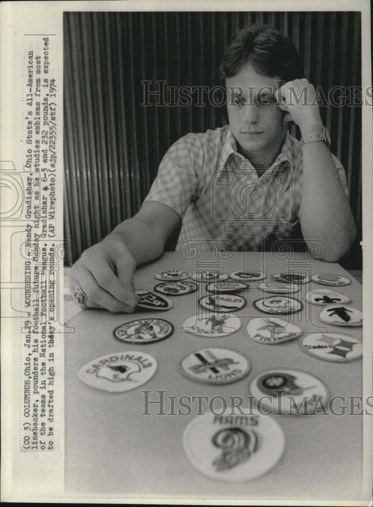 1974 Press Photo Randy Gradisher studies emblems of NFL teams. - cvb76815 - Historic Images