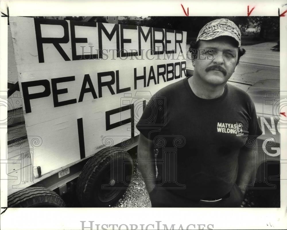 1989 Press Photo George Matyas displays the signs in protest of Japane ...