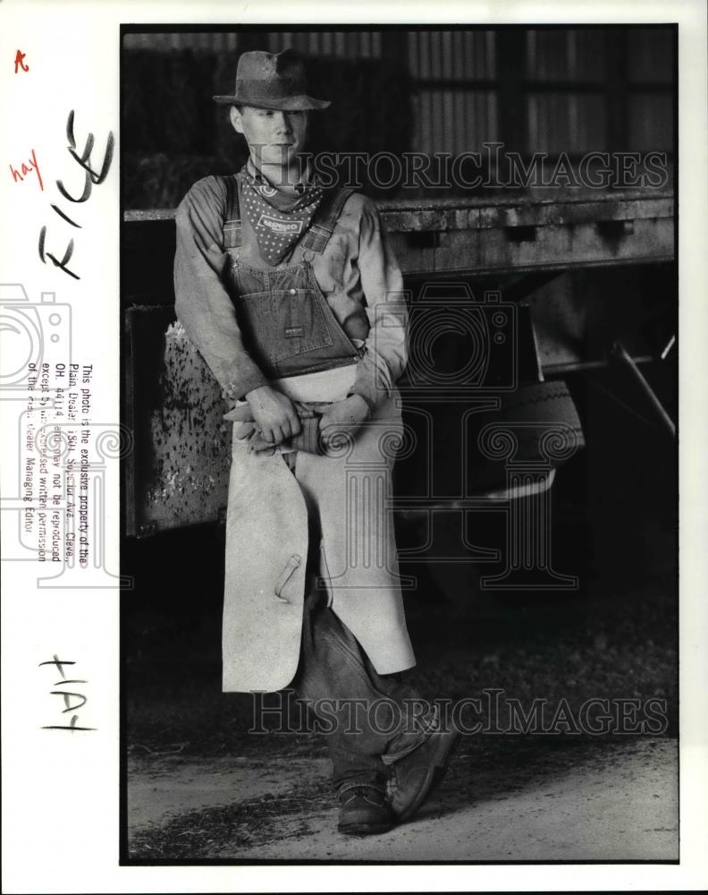1988 Press Photo Mark Marshall rests against the flatbed truck- Hay delivery - Historic Images