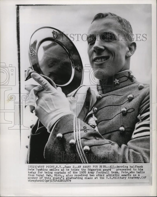 1959 Press Photo Football-Pete Dawkins, smiles as he holds the Edgerton award. - Historic Images