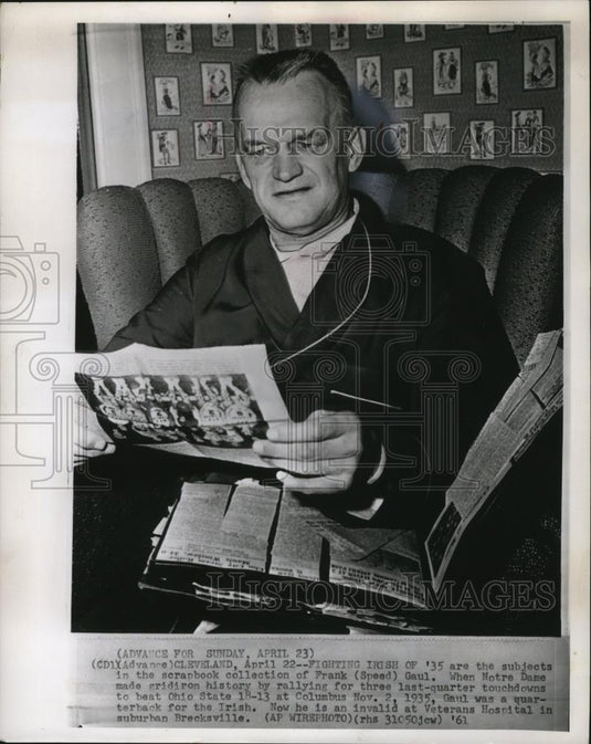 1961 Press Photo Frank Gaul looks through collections of the '35 football action - Historic Images