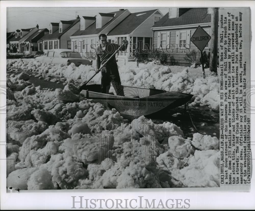 1961 Wire Photo Man pushes a boat down street of the Kenberma Park area of Hull - Historic Images