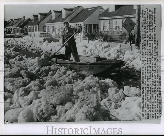 1961 Wire Photo Man pushes a boat down street of the Kenberma Park area of Hull - Historic Images
