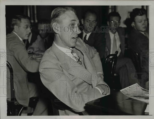 1937 Press Photo Unknown man in suit sitting at a table - net23107 - Historic Images