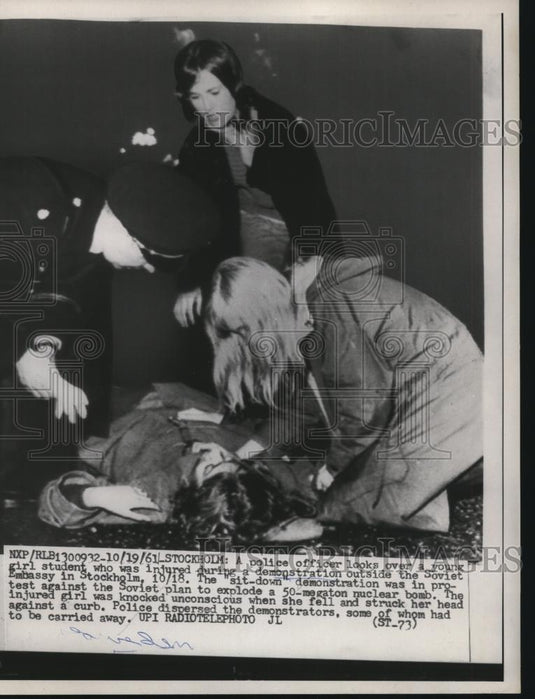 1961 Press Photo Police Officer Looks Over Student Injured During Demonstration - Historic Images