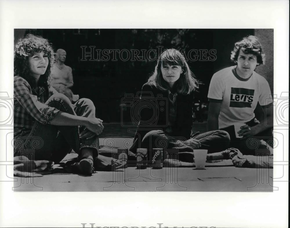 Press Photo Teen group sitting on the sidewalk - cva20353 - Historic Images