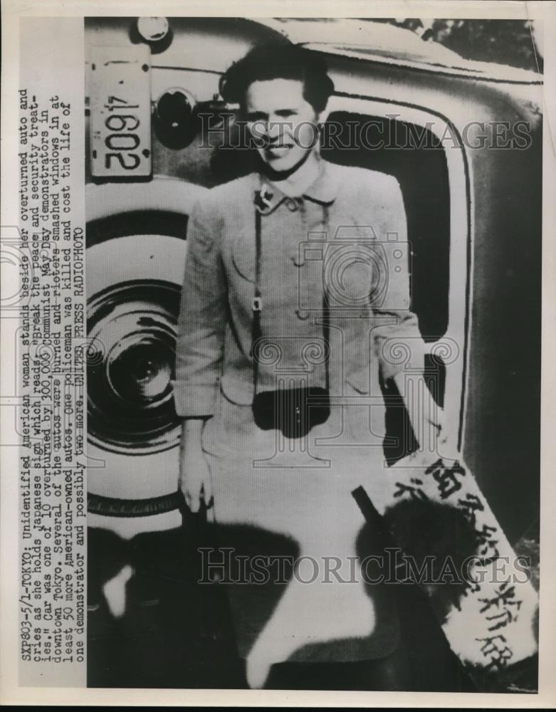 1959 Press Photo American Woman &amp; Her Overturned Car in Tokyo Japan  - nef36329 - Historic Images