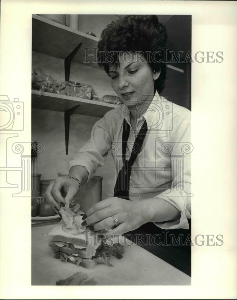 1983 Press Photo Sophia Prevey fixes her special triple decker sandwich - Historic Images