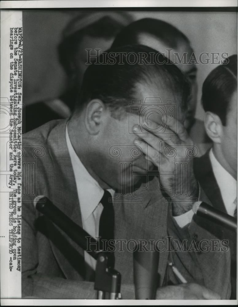 1954 Press Photo Joseph McCarthy covers his face as he listens to testimony - Historic Images