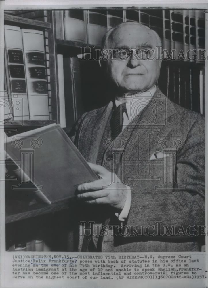 1957 Press Photo Felix Frankfurter posing with book of statues in his office - Historic Images