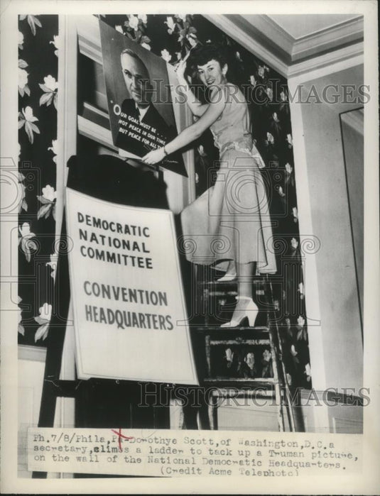 1948 Press Photo Dorothy Scott climbs a ladder to tack up a Truman picture - Historic Images
