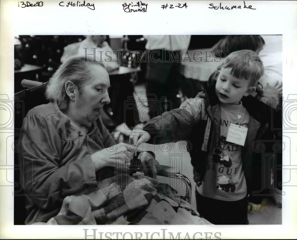 1993 Press Photo A little boy gives care to the senior citizen - orb49887 - Historic Images
