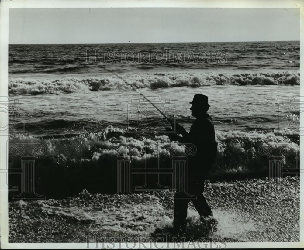 Press Photo A lone fisherman at surfline of an ocean - net33804 - Historic Images