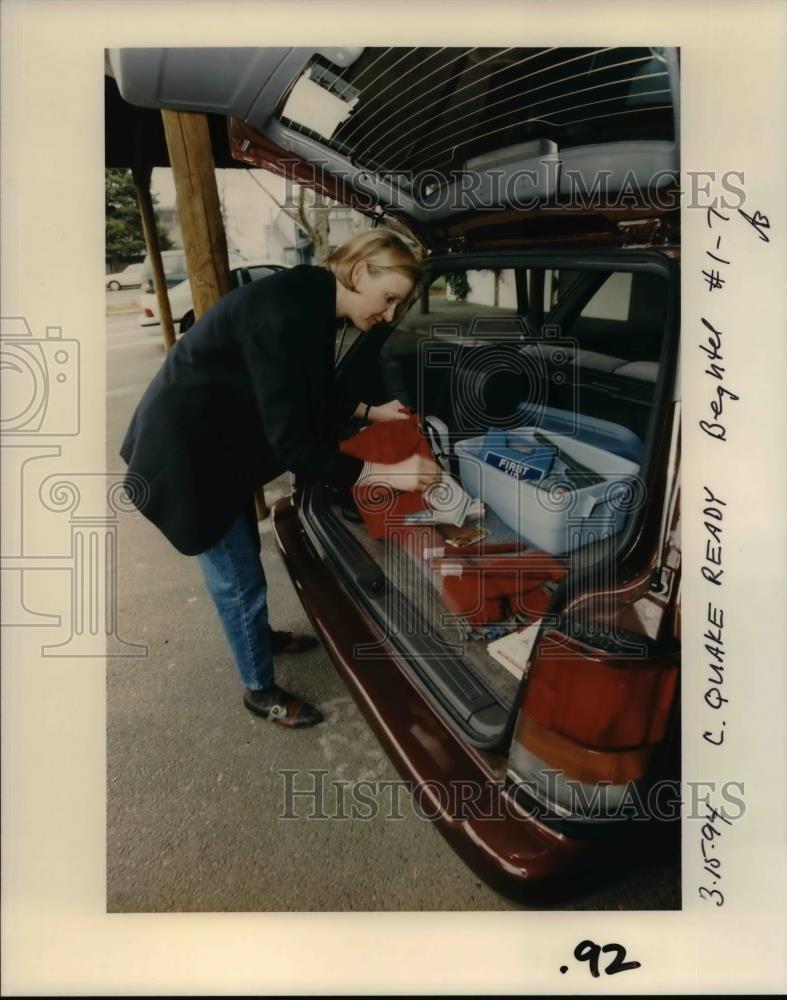 1994 Press Photo Lady checking her first aid kit at back of car for disasters - Historic Images
