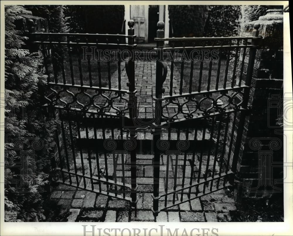 1983 Press Photo Wrought iron gate onto moss covered brick walkway - orb11596 - Historic Images