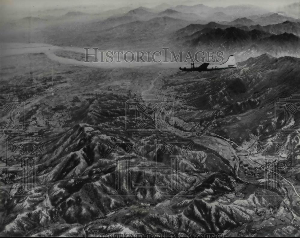 1950 Press Photo A B-29 flies over rough Korea terrain - orb25273 - Historic Images