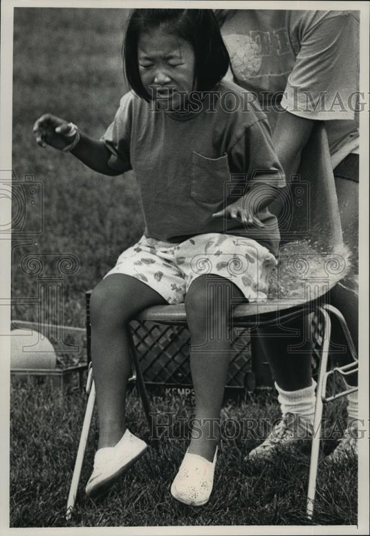 1991 Press Photo Leah Pintsak Breaks Water Balloon in Crazy Olympics Relay Race - Historic Images
