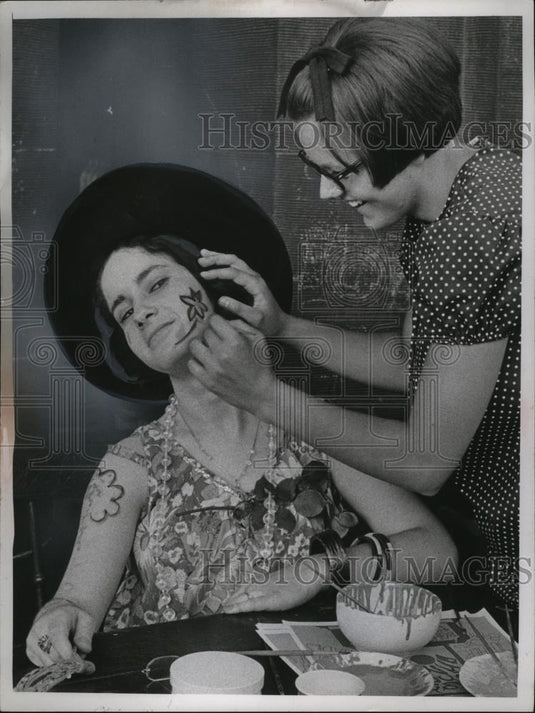 1957 Press Photo Barbara Dery gets flowers painted on her face by Marge Kuta - Historic Images