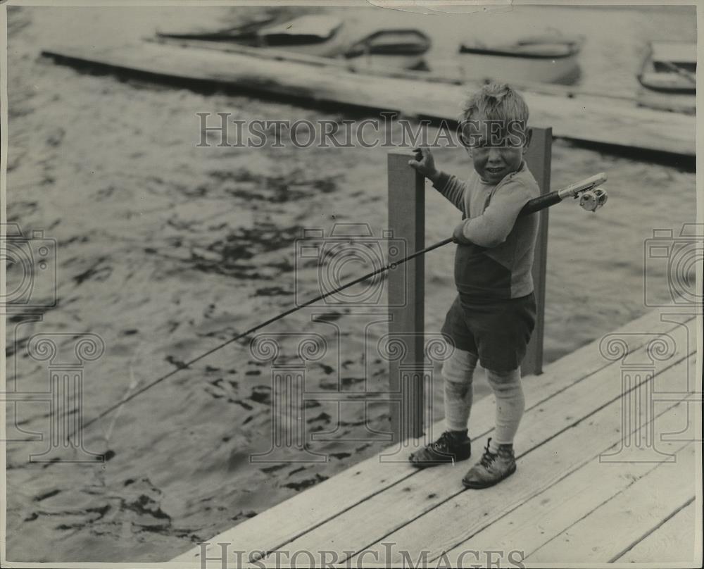 Press Photo Young Boy Fishing off a Dock in the Fresh Air and Sunshine - Historic Images