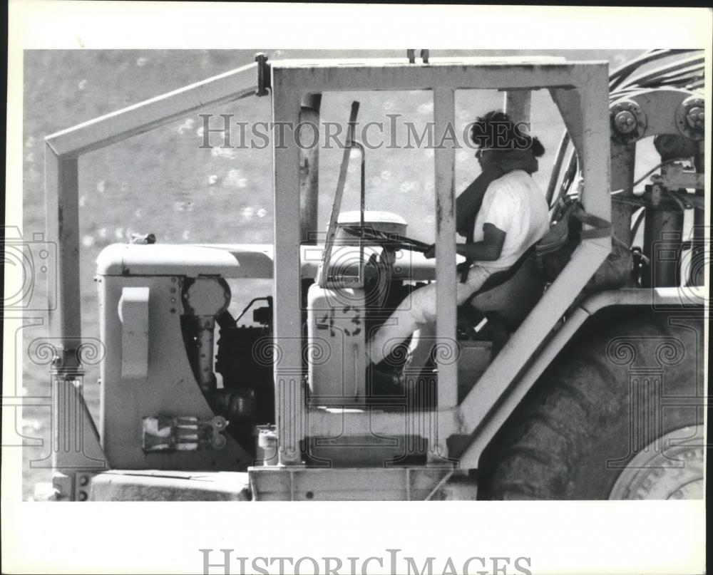 1990 Press Photo Operator of a road scraper wears a life jacket - spa48488 - Historic Images