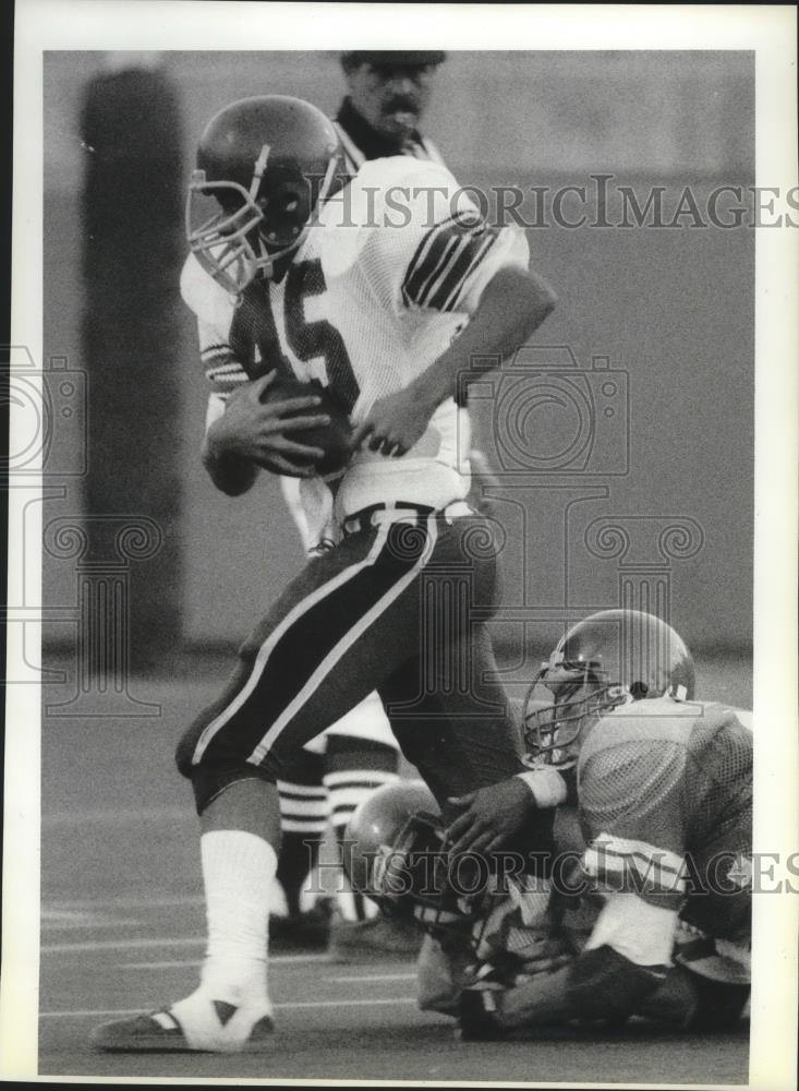 1988 Press Photo U-Hi football player, Chris Baldwin, drags Rogers defenders - Historic Images