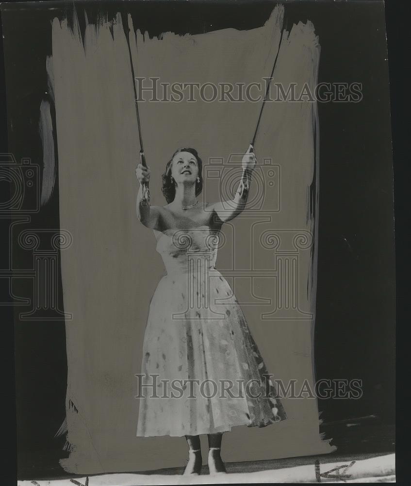 1956 Press Photo A beautiful lady holding two poles - sps06302 - Historic Images