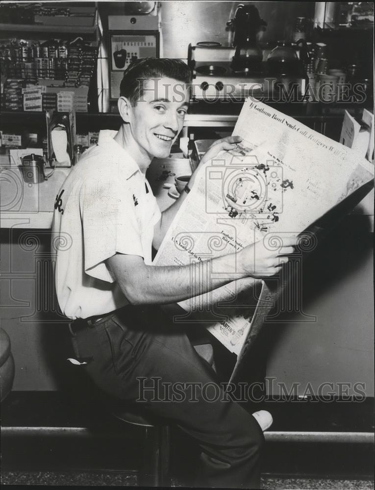 1963 Press Photo Bowler Billy Golembiewski reads the paper in a diner - sps06488 - Historic Images