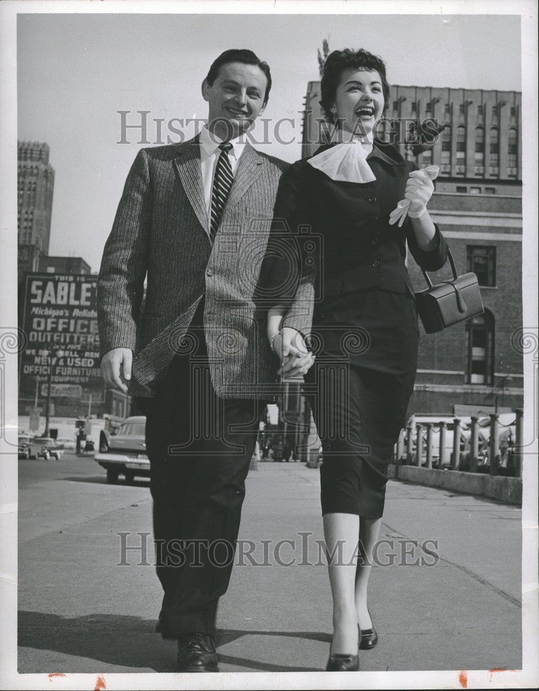 1957 Press Photo Man and Woman Walking Downtown - Historic Images