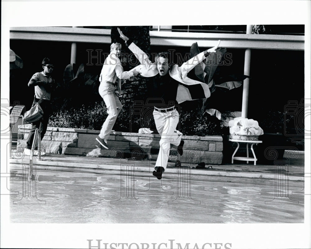 Press Photo Man Jumps Into Pool Fully Dressed For A Scene In A Movie - Historic Images