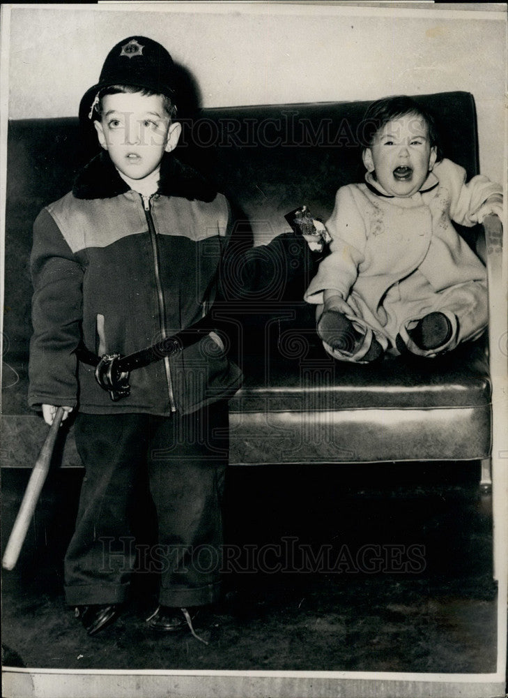 Child Tries To Give Crying Baby His Candy At London Airport - Historic Images