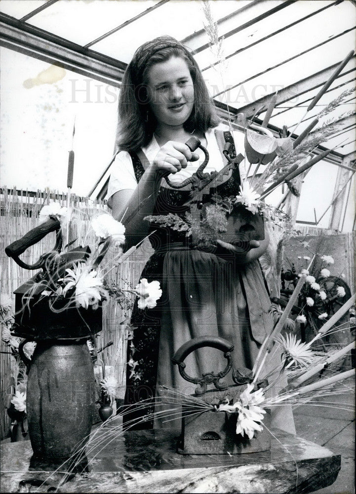 1965 Flower arrangements made with odd items as canisters - Historic Images