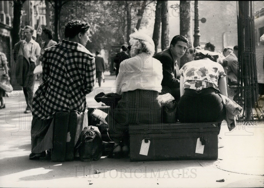 1953, Tourists sitting on their Luggage during train strike - Historic Images