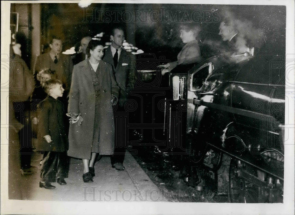 1957 The Queen and Prince Phillip and their children at a train - Historic Images