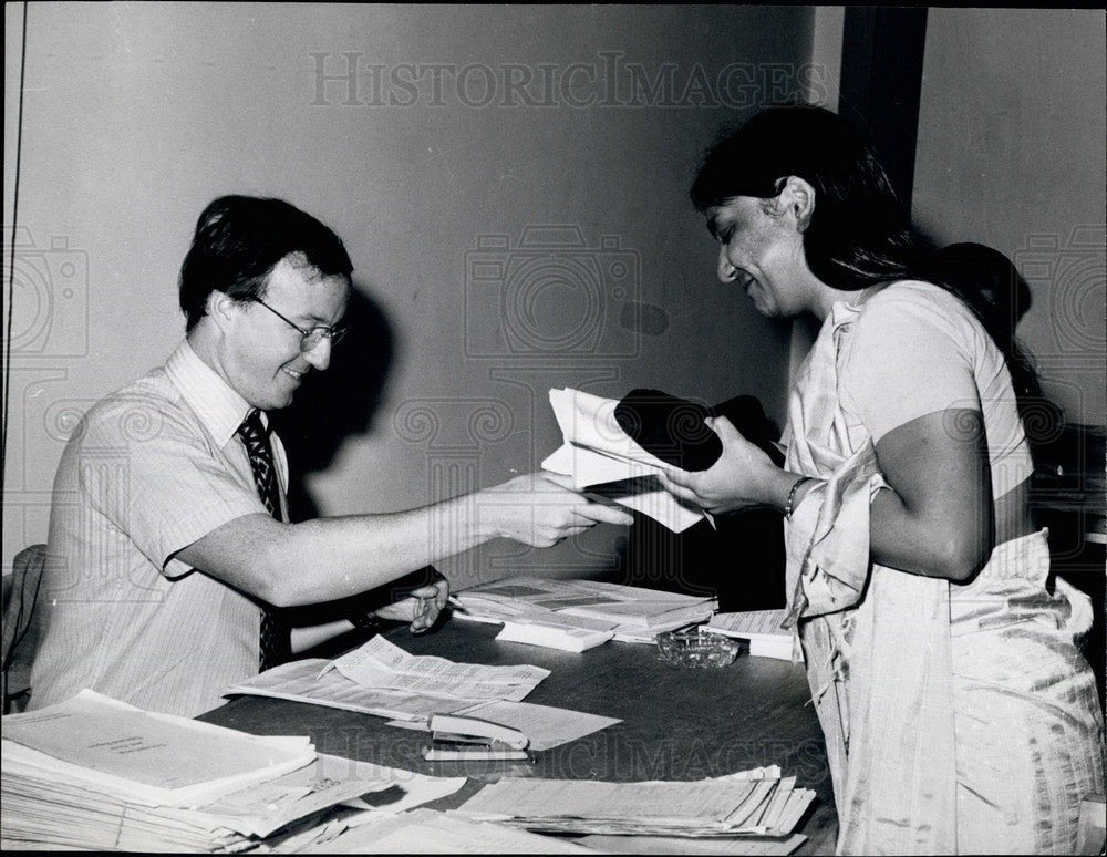 Press Photo Canadian official processes an Asian woman&#39;sapplication - Historic Images