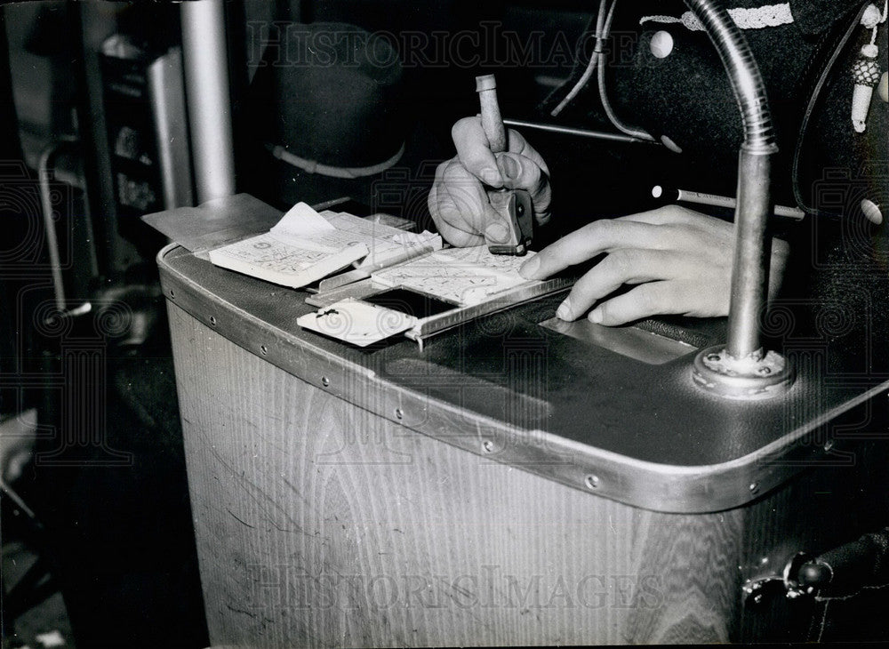 Press Photo The Conductor Uses A Rubber Stamp On His Tickets - Historic Images