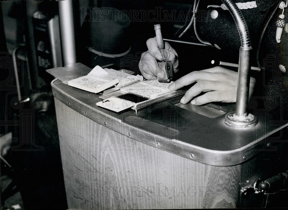 Press Photo The Conductor Uses A Rubber Stamp On His Tickets - Historic Images