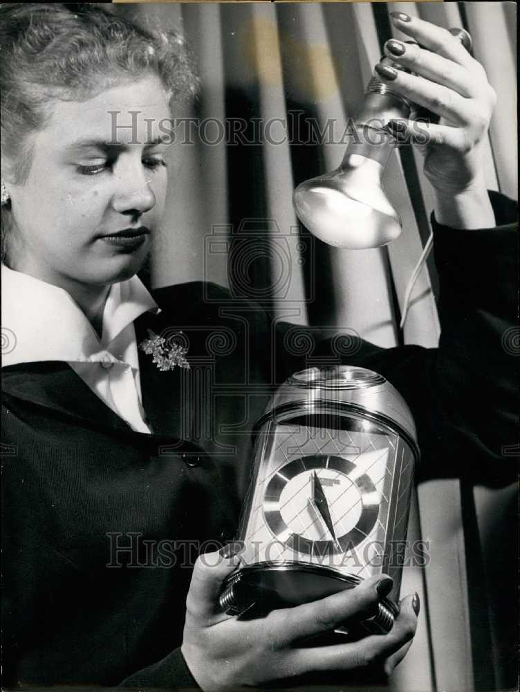 1954 A Girl Holds A Light Above A Clock At The Clock Trade Fair - Historic Images