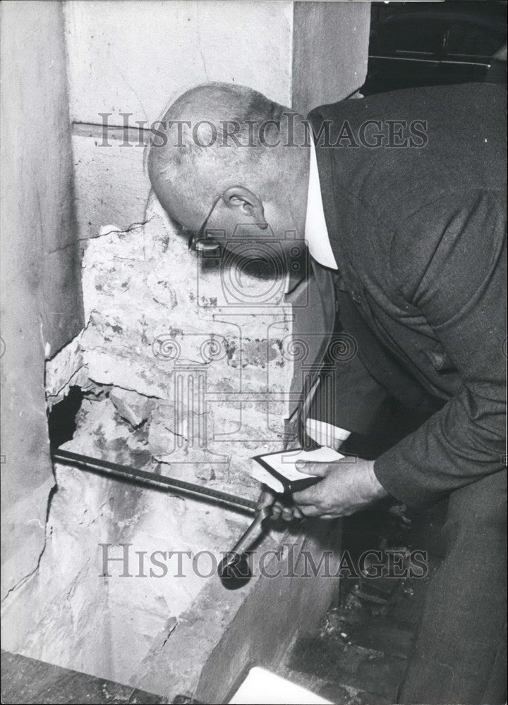 Press Photo Man Looking At Hole In Fireplace - KSB43205 - Historic Images