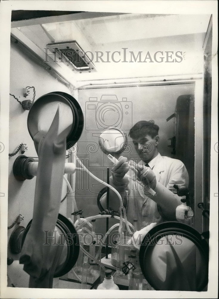 1957 Mr. G. Ramsay using box used for handling Radio Active Carbon - Historic Images