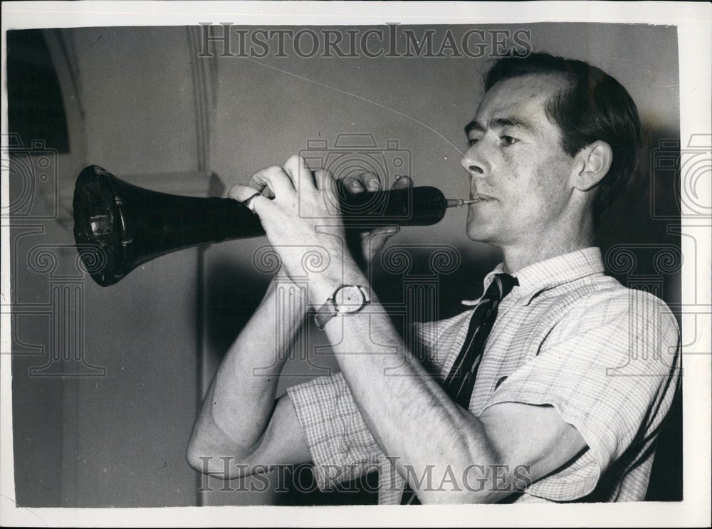 1955, The Chelsea Autumn antiques Fair Mr.I.Mackay tries a shawm - Historic Images